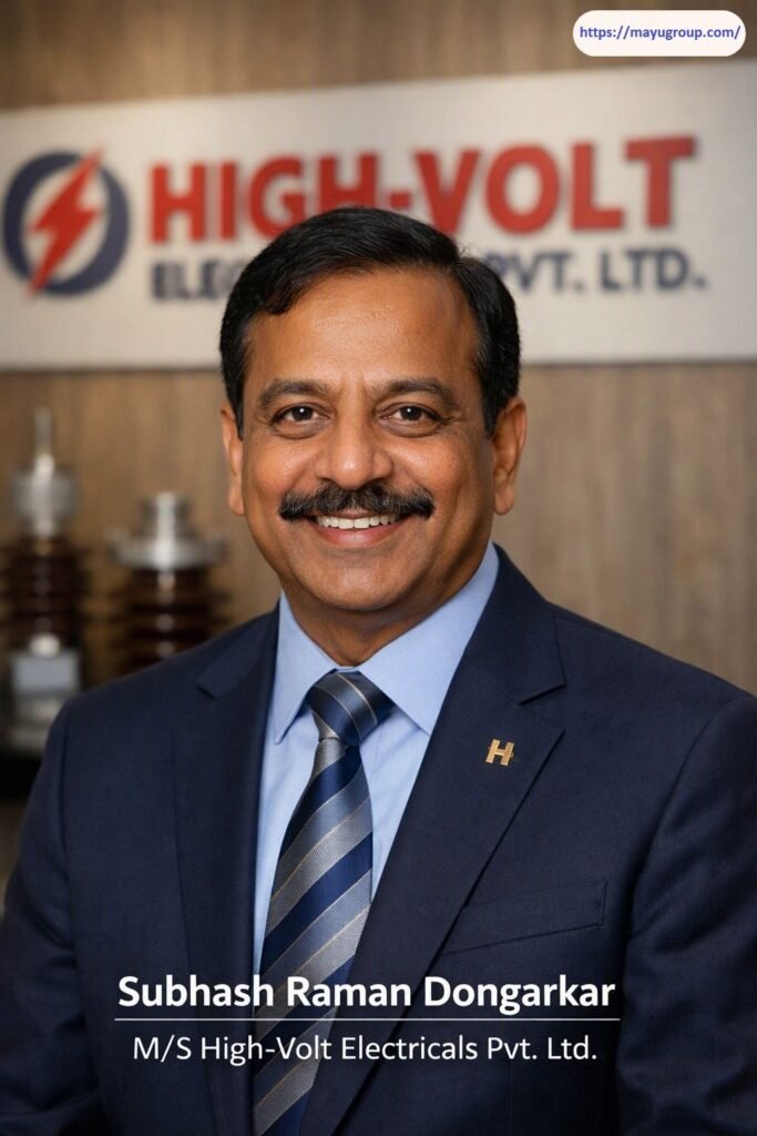Professional corporate portrait of Subhash Raman Dongarkar wearing a dark blue suit jacket, light blue shirt, and patterned tie, set against an out-of-focus HIGH-VOLT company wall logo and electrical component equipment.